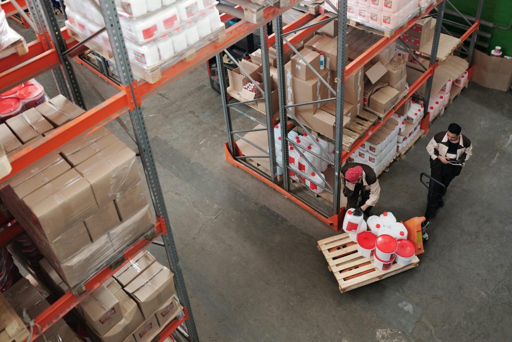 High angle view of workers organizing inventory in a busy warehouse.